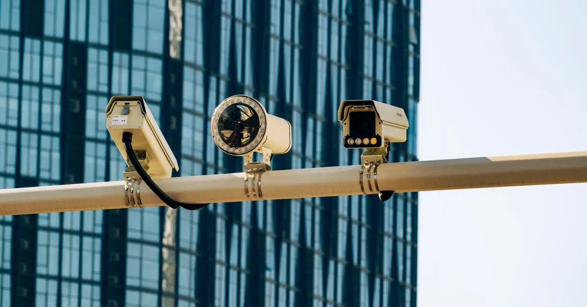 A dome CCTV camera mounted on the outside wall of a business premises