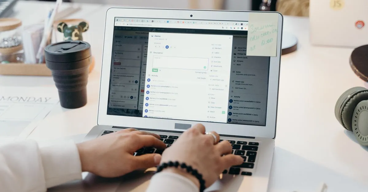 A person working on a laptop in a bright office, managing business email